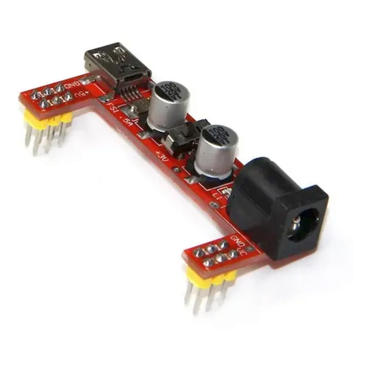 Piros MB102 jellegű breadboard tápegység modul, kapcsolóval, kondenzátorokkal és jelölt 5 V, 3,3 V, GND kivezetésekkel.